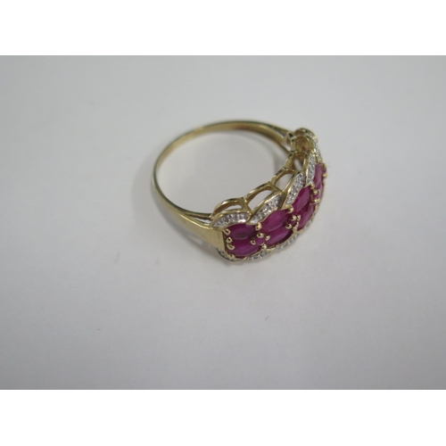 128 - A ten stone ruby and diamond 9ct yellow gold ring - head size 22mm x 11mm - ring size S