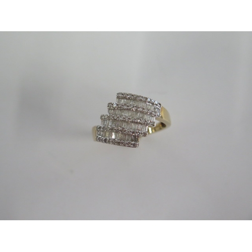 129 - A 9ct yellow gold four band diamond ring - head size approx 17mm x 15mm - ring size approx S