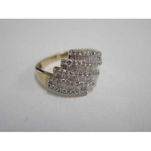 129 - A 9ct yellow gold four band diamond ring - head size approx 17mm x 15mm - ring size approx S