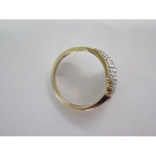 129 - A 9ct yellow gold four band diamond ring - head size approx 17mm x 15mm - ring size approx S