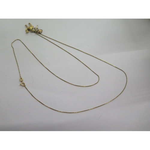 137 - An 18ct yellow gold 64cm chain with four gilt pendants - total weight approx 5 grams