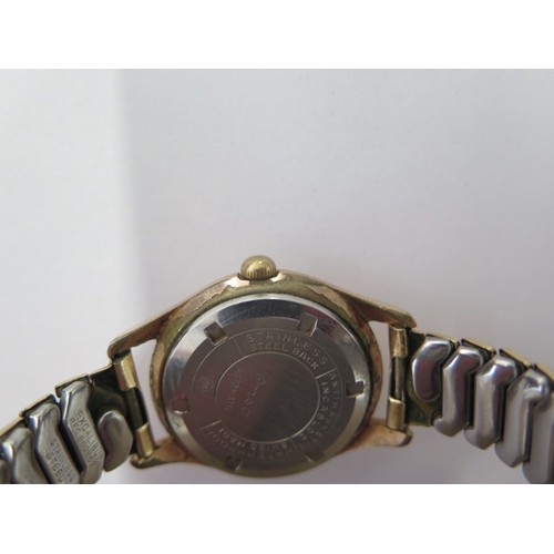 22 - An Onsa gold plated manual wind/super automatic wristwatch - 33mmm case - on a sprung plated strap -... 