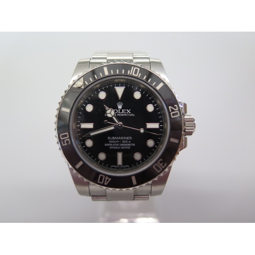 A 2014 Rolex Oyster Perpetual Submariner stainless steel bracelet gentleman's watch with black dial and bezel - 44mm wide including button, model 114060, serial T9668765 bracelet 97200 - with box, tag, paperwork and outer box - in very good condition
