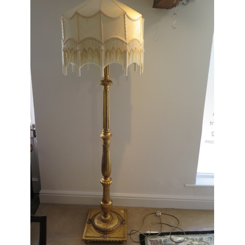 542 - A gilt wood lamp and shade - in working order - Height 195cm