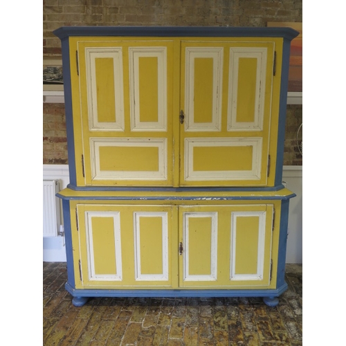 547 - A 19th century continental painted pine two part cupboard on cupboard with panelled doors ad sides -... 