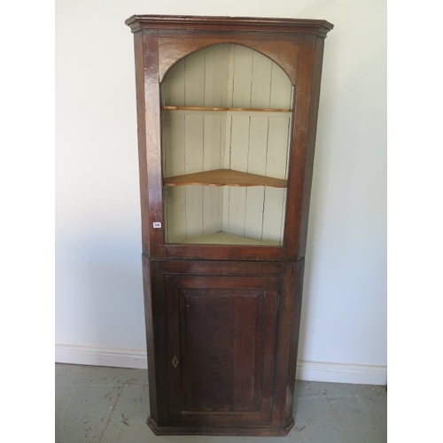 548 - A Georgian oak two part corner cupboard with a base door and painted interior - Height 184cm x Width... 