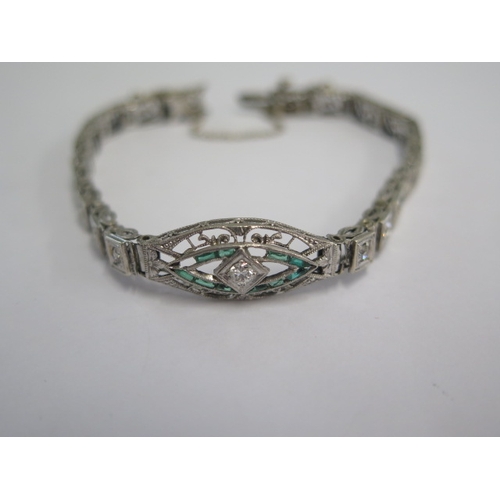 72 - A white metal Art Deco diamond and emerald bracelet - head size 24mm x 10mm - approx weight 9.4 gram... 