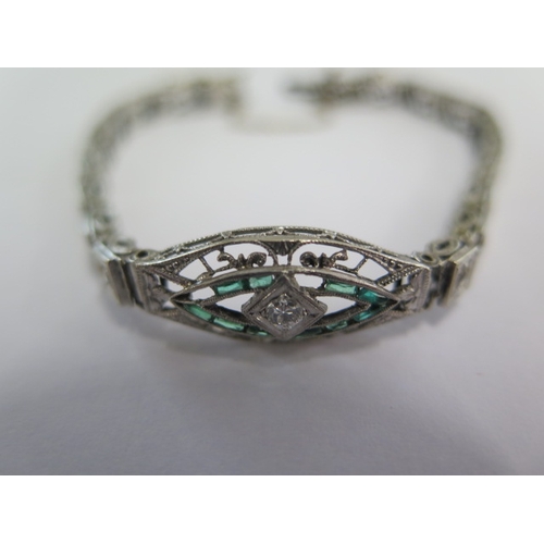 72 - A white metal Art Deco diamond and emerald bracelet - head size 24mm x 10mm - approx weight 9.4 gram... 