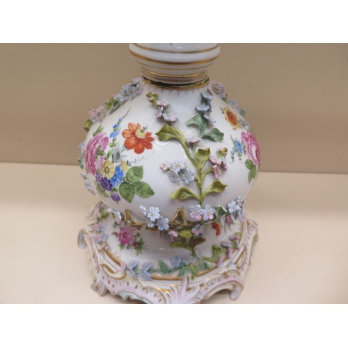 413 - A Continental floral encrusted porcelain oil lamp stand - Height 61cm - some foliate losses and firi... 