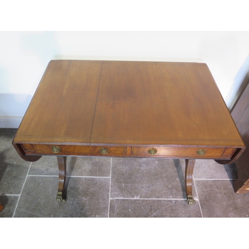 526 - A 19th century mahogany drop leaf sofa table with two active and two dummy drawers on twin pillar su... 