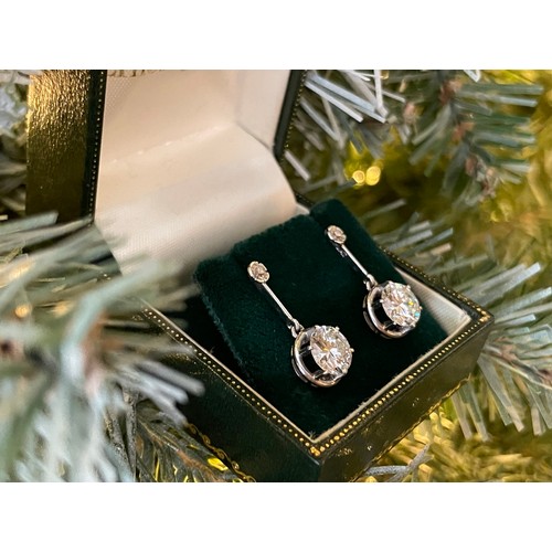 A superb pair of single stone diamond drop earrings - The round brilliant cut stones each measuring approx 1.45ct of diamonds with minimal inclusions set in platinum - drop length approx 2.3cm - gross weight approx 5.5 grams