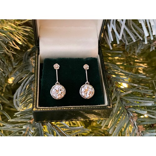 101 - A superb pair of single stone diamond drop earrings - The round brilliant cut stones each measuring ... 