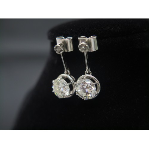 101 - A superb pair of single stone diamond drop earrings - The round brilliant cut stones each measuring ... 