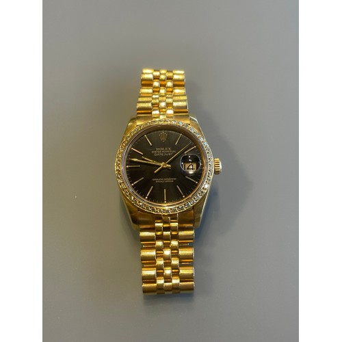 276 - A gents Rolex Datejust in 18ct yellow gold, black dial with diamond bezel, with Rolex 18ct yellow go... 