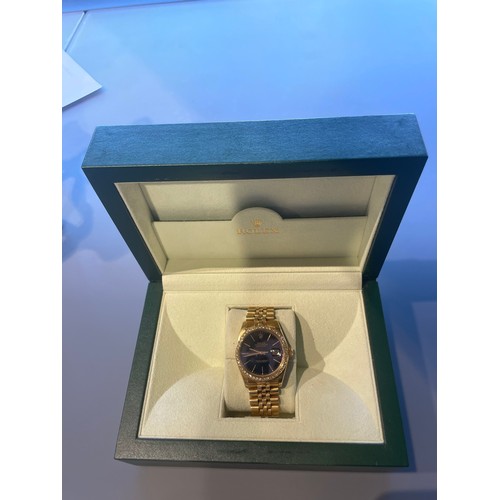 276 - A gents Rolex Datejust in 18ct yellow gold, black dial with diamond bezel, with Rolex 18ct yellow go... 