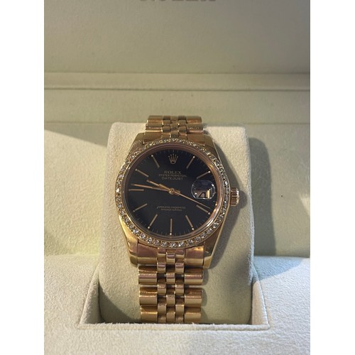 276 - A gents Rolex Datejust in 18ct yellow gold, black dial with diamond bezel, with Rolex 18ct yellow go... 