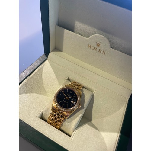 276 - A gents Rolex Datejust in 18ct yellow gold, black dial with diamond bezel, with Rolex 18ct yellow go... 