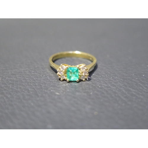 109 - An 18ct yellow gold (tested) emerald and diamond ring, emerald has natural inclusions, diamonds brig... 