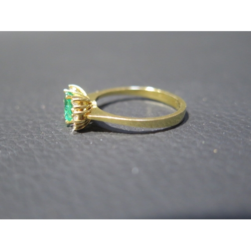 109 - An 18ct yellow gold (tested) emerald and diamond ring, emerald has natural inclusions, diamonds brig... 