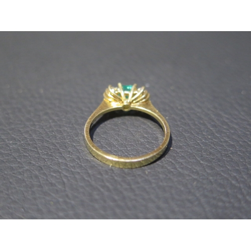 109 - An 18ct yellow gold (tested) emerald and diamond ring, emerald has natural inclusions, diamonds brig... 