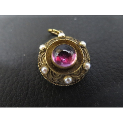 125 - A Victorian 15ct yellow gold - unmarked but tested - Etruscan Revival pendant with cabochon garnet a... 