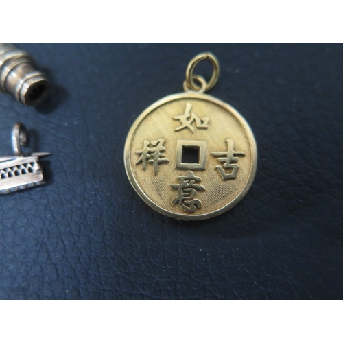 129 - A 14ct yellow gold pendant with Chinese characters - approx 1.8cm - weight approx 2.5 grams with two... 