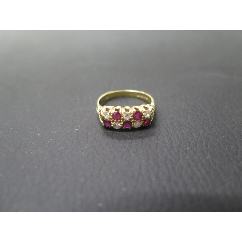 163 - An 18ct yellow gold diamond and ruby double row ring size O - weight approx 5.3 grams