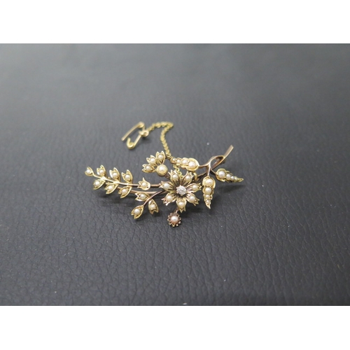 175 - A 14ct yellow gold pearl and diamond brooch, the central flower shape set with old cut diamond and p... 