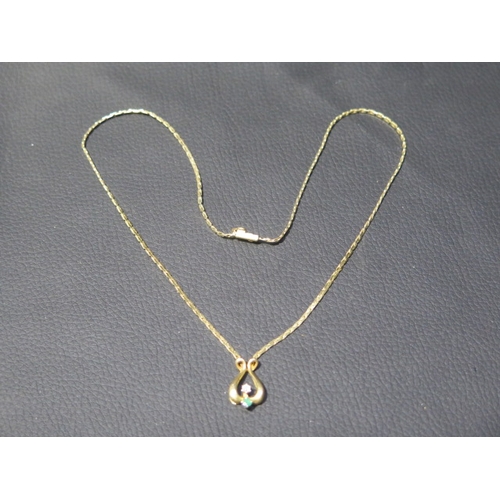 196 - A 9ct yellow gold pendant and chain, lyre shaped pendant with emerald and diamond accent approx 1.5c... 