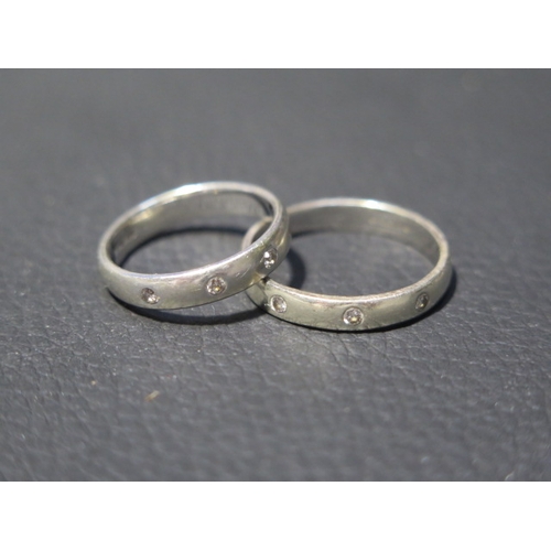 197 - Two 9ct white gold bands each set with three small diamonds - ring sizes S/T & N - total weight appr... 