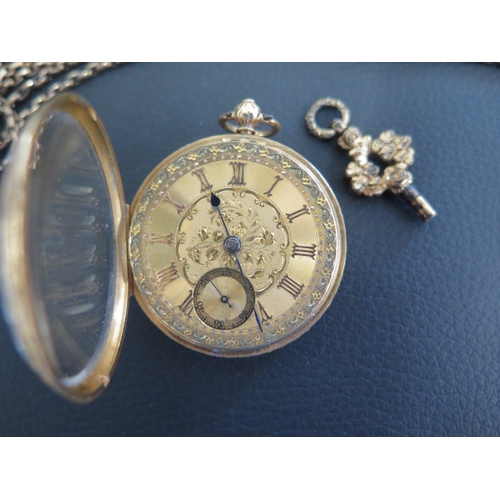 251 - An 18ct gold pocket watch with its key and case - Not working - and a gold plated chain