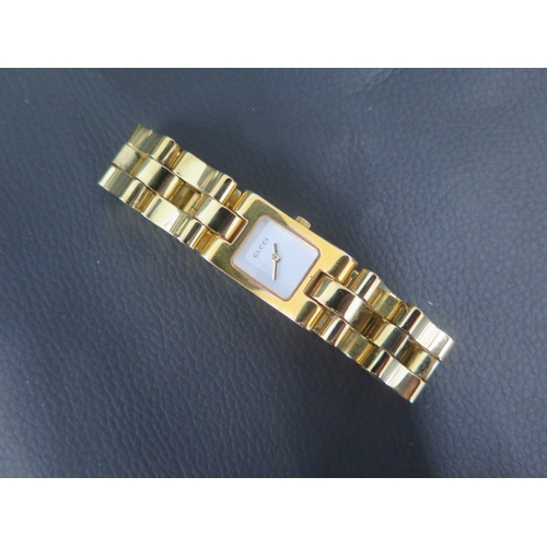 259 - A ladies gold coloured Gucci quartz wristwatch, rectangular case approx 17mm x 29mm with box, origin... 