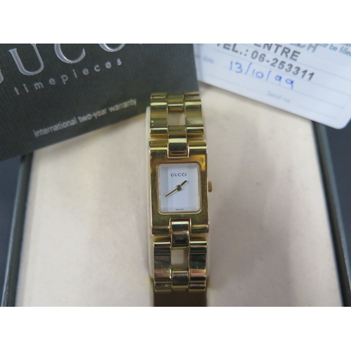 259 - A ladies gold coloured Gucci quartz wristwatch, rectangular case approx 17mm x 29mm with box, origin... 