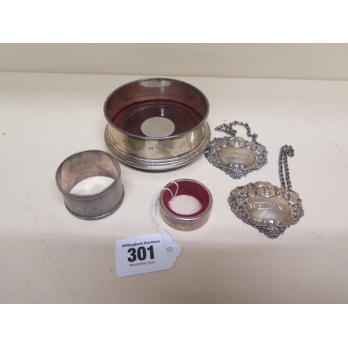 301 - A silver caster - approx 10cm diameter together with a pair of silver decanter labels and two silver... 