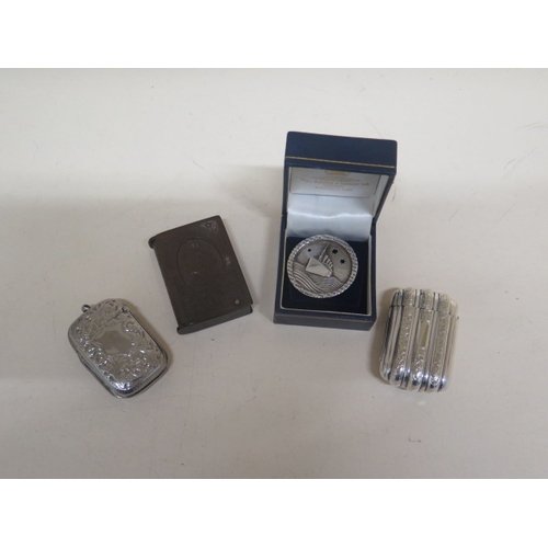 405 - Two white metal vesta cases - approx 5cm and 4.5cm - together with a Bakelite vesta case Queen Victo... 