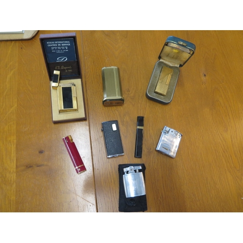 418 - A Dupont lighter boxed, a Dunhill and six others