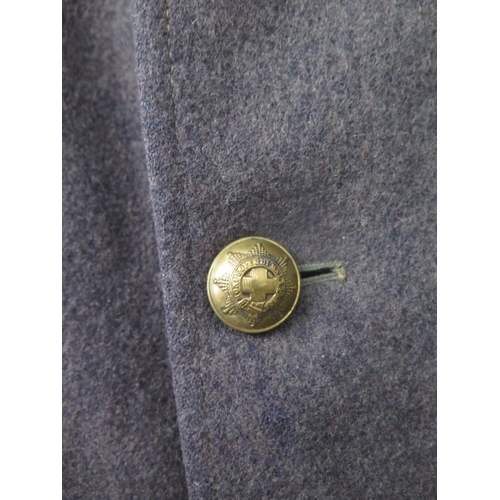 422 - A British Military overcoat with brass button for Coldstream Guards together with a British Army lea... 