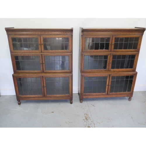 505 - A pair of oak Minty three tier stacking bookcases - one with damaged glass - Height 118cm x 90cm