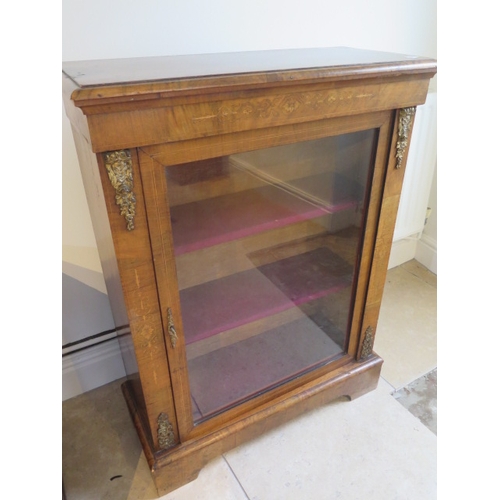 561 - A mid 19th century pier cabinet fitted with a single glazed door enclosing two shelves - 102cm x 76c... 