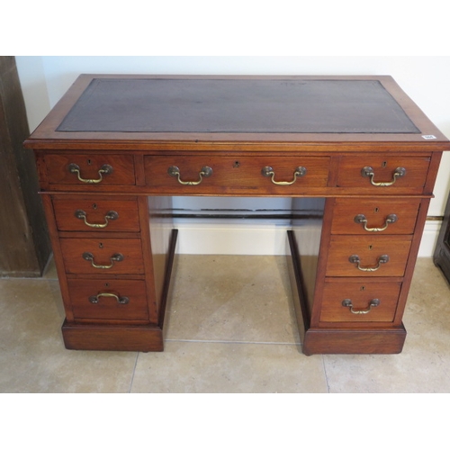 564 - A Victorian walnut nine drawer pedestal desk with inset leather scriber - 106cm x 58cm x 77cm