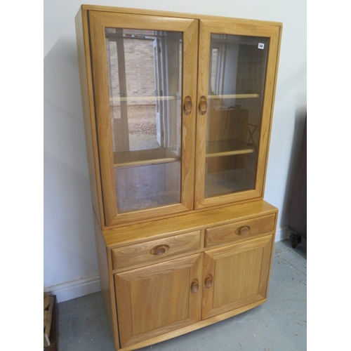 566 - A blonde Ercol cabinet bookcase - in good condition - Height 160cm x Width 92cm