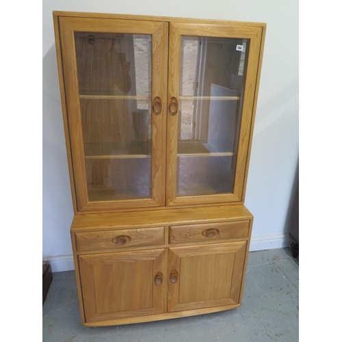 566 - A blonde Ercol cabinet bookcase - in good condition - Height 160cm x Width 92cm