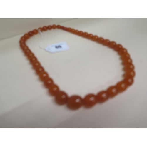 66 - A graduated amber bead necklace - approx 66cm - weight approx 73 grams