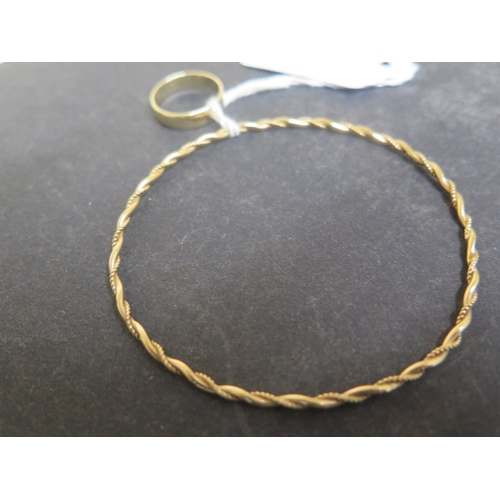 73 - A 9ct yellow gold bangle - approx 6.5cm diameter - weight approx 5.3 grams - together with a 9ct gol... 