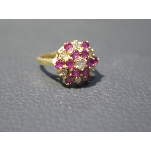 77 - An 18ct yellow gold diamond and ruby cluster ring size J/K - weight approx 5.1 grams