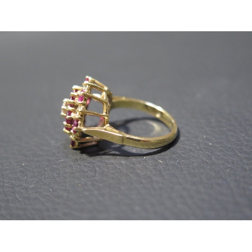 77 - An 18ct yellow gold diamond and ruby cluster ring size J/K - weight approx 5.1 grams