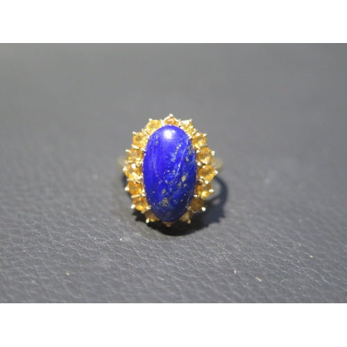 78 - An 18ct yellow gold Lapis Lazuli and citrine ring - the central oval Lapis approx 1.5cm surrounded b... 