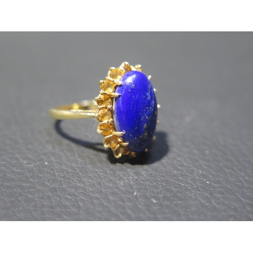 78 - An 18ct yellow gold Lapis Lazuli and citrine ring - the central oval Lapis approx 1.5cm surrounded b... 