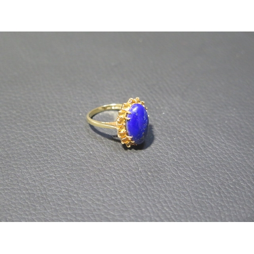 78 - An 18ct yellow gold Lapis Lazuli and citrine ring - the central oval Lapis approx 1.5cm surrounded b... 