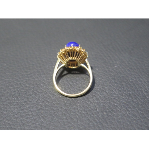 78 - An 18ct yellow gold Lapis Lazuli and citrine ring - the central oval Lapis approx 1.5cm surrounded b... 